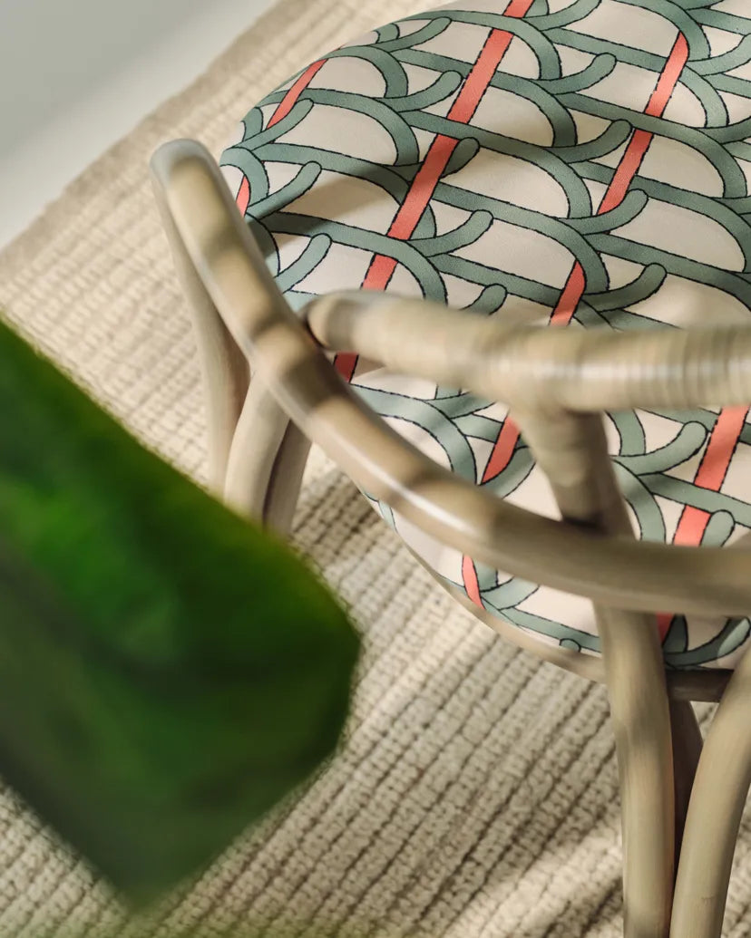 BISTRA upholstered chair with an olive rattan base