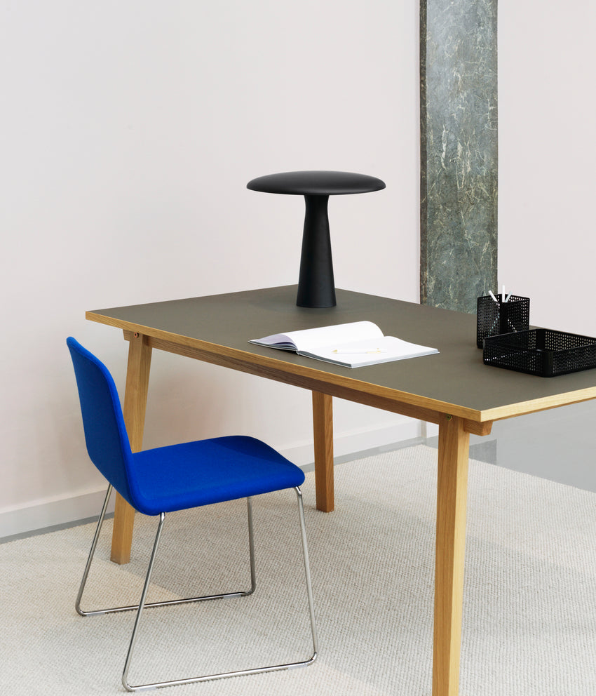 A chair upholstered Just with a black base