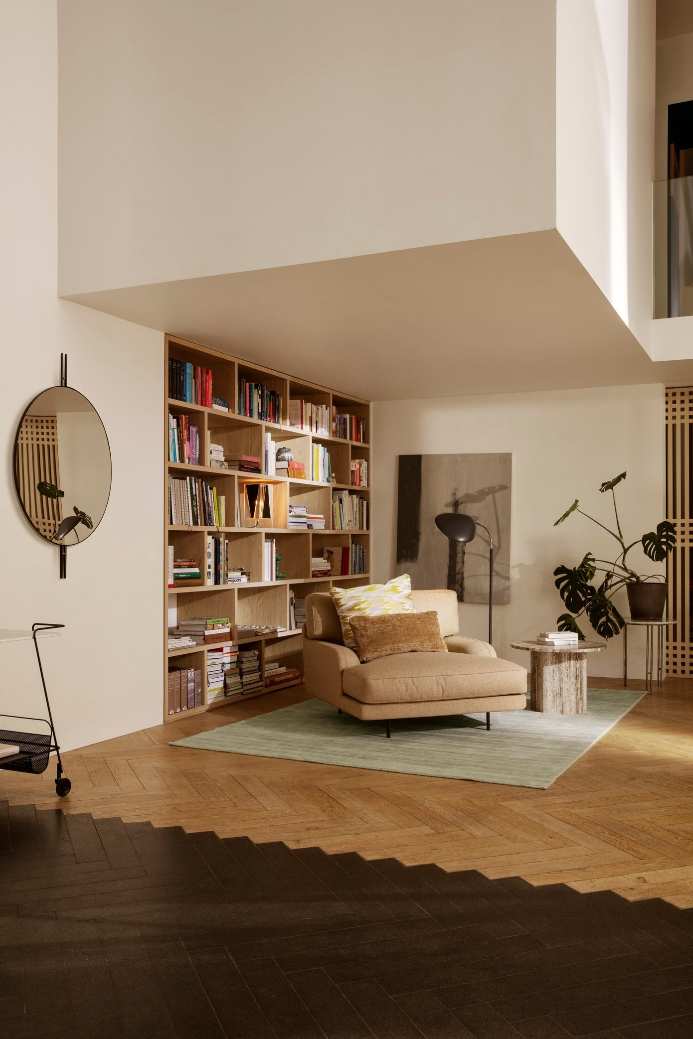 Upholstered FLANEUR armchair with a brass base