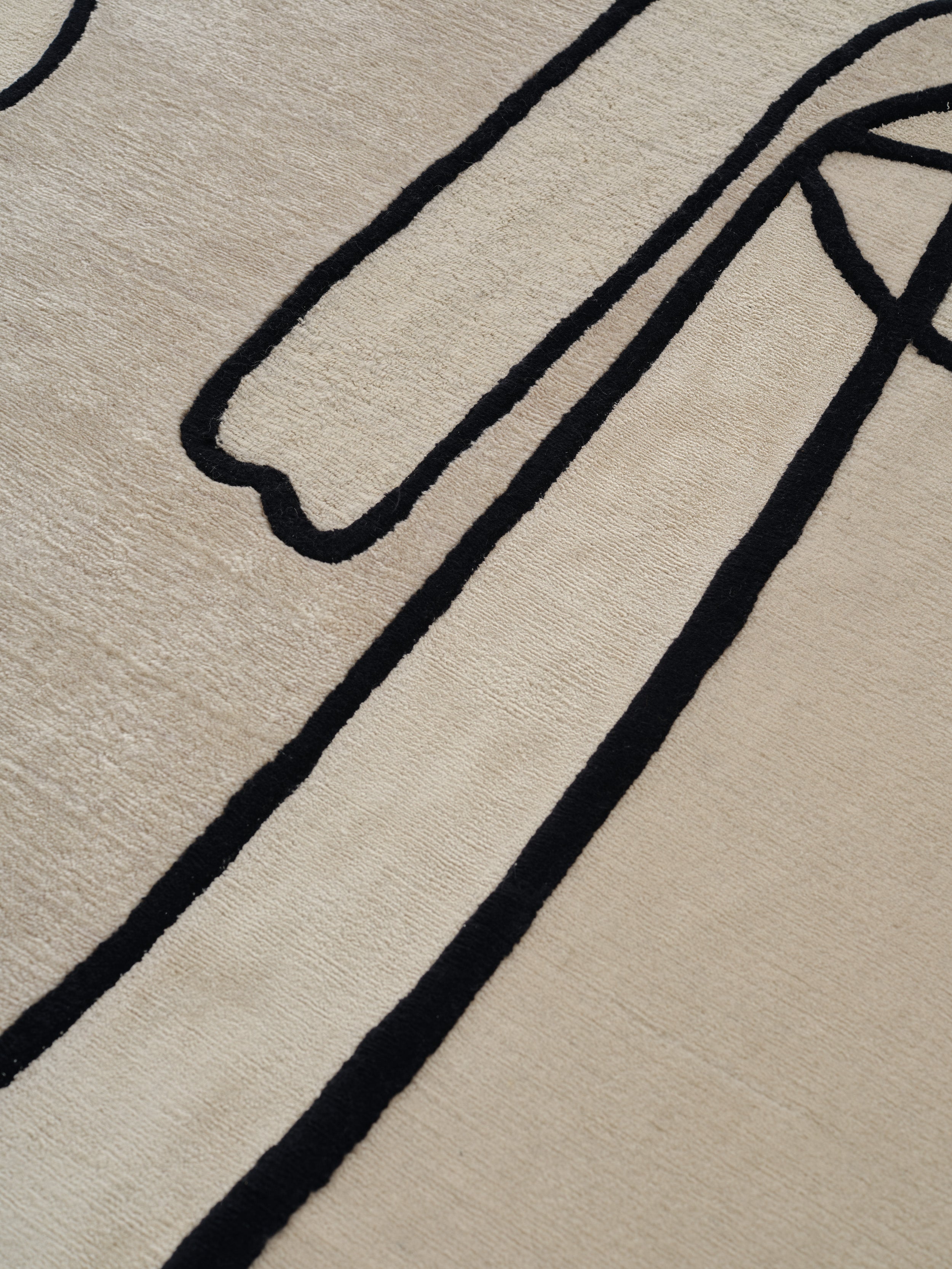SLANTED SELF beige rug with black
