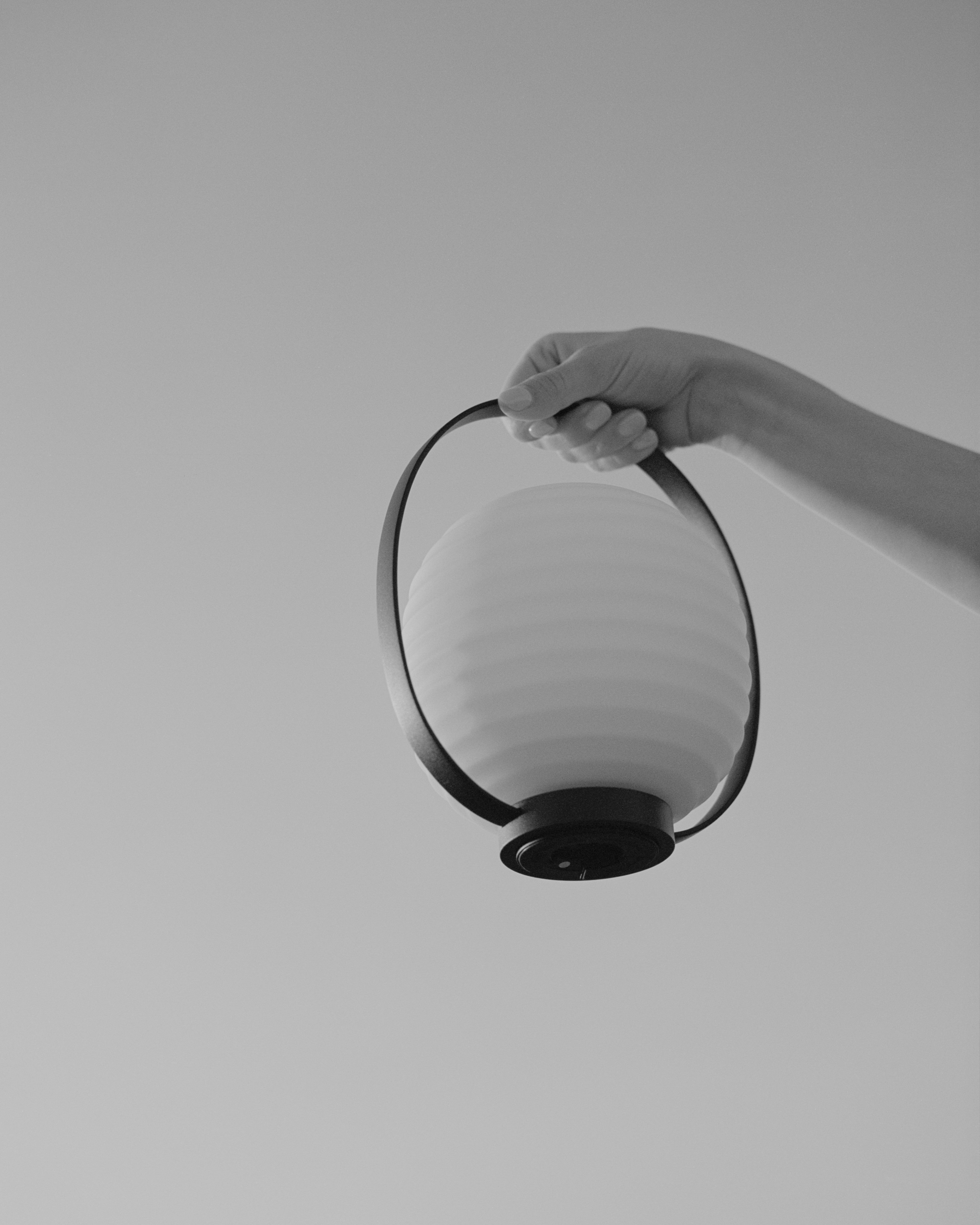 Lantern white portable lamp with a black handle