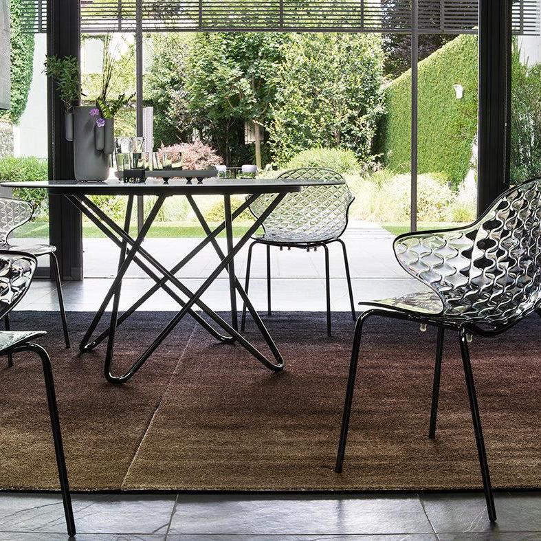 SAINT TROPEZ chair with a transparent seat and a golden metal base