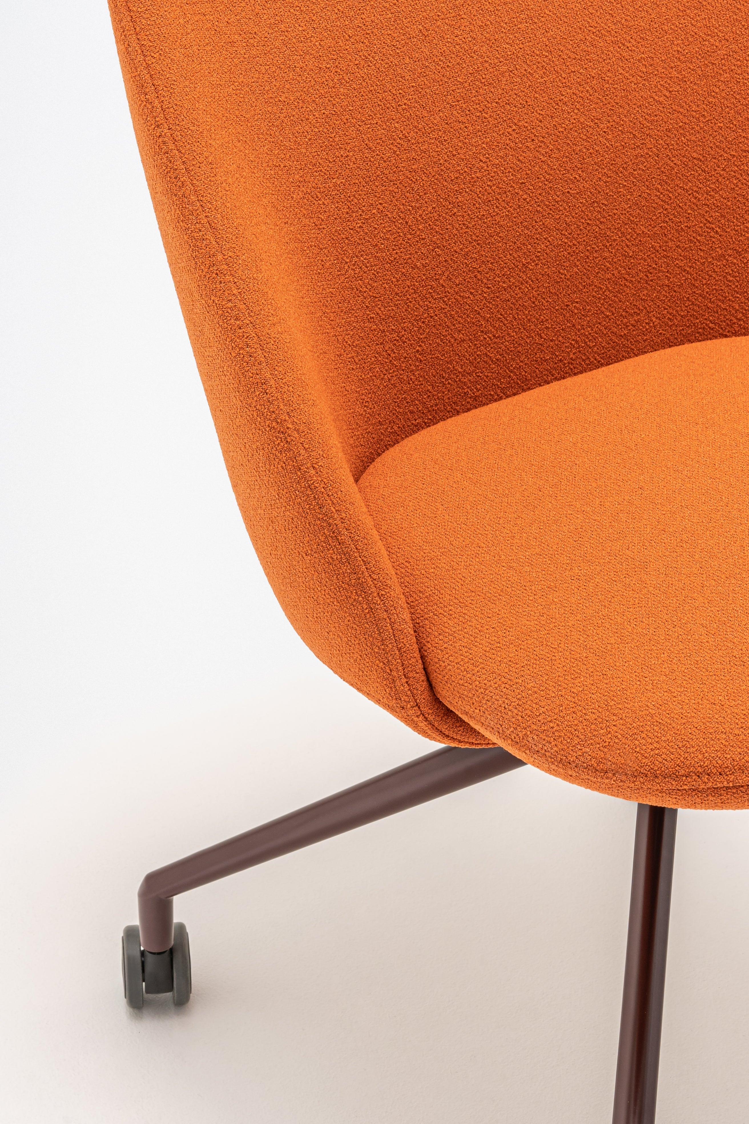 Swivel armchair with low back, a metal parallel base with wheels to a hard surface