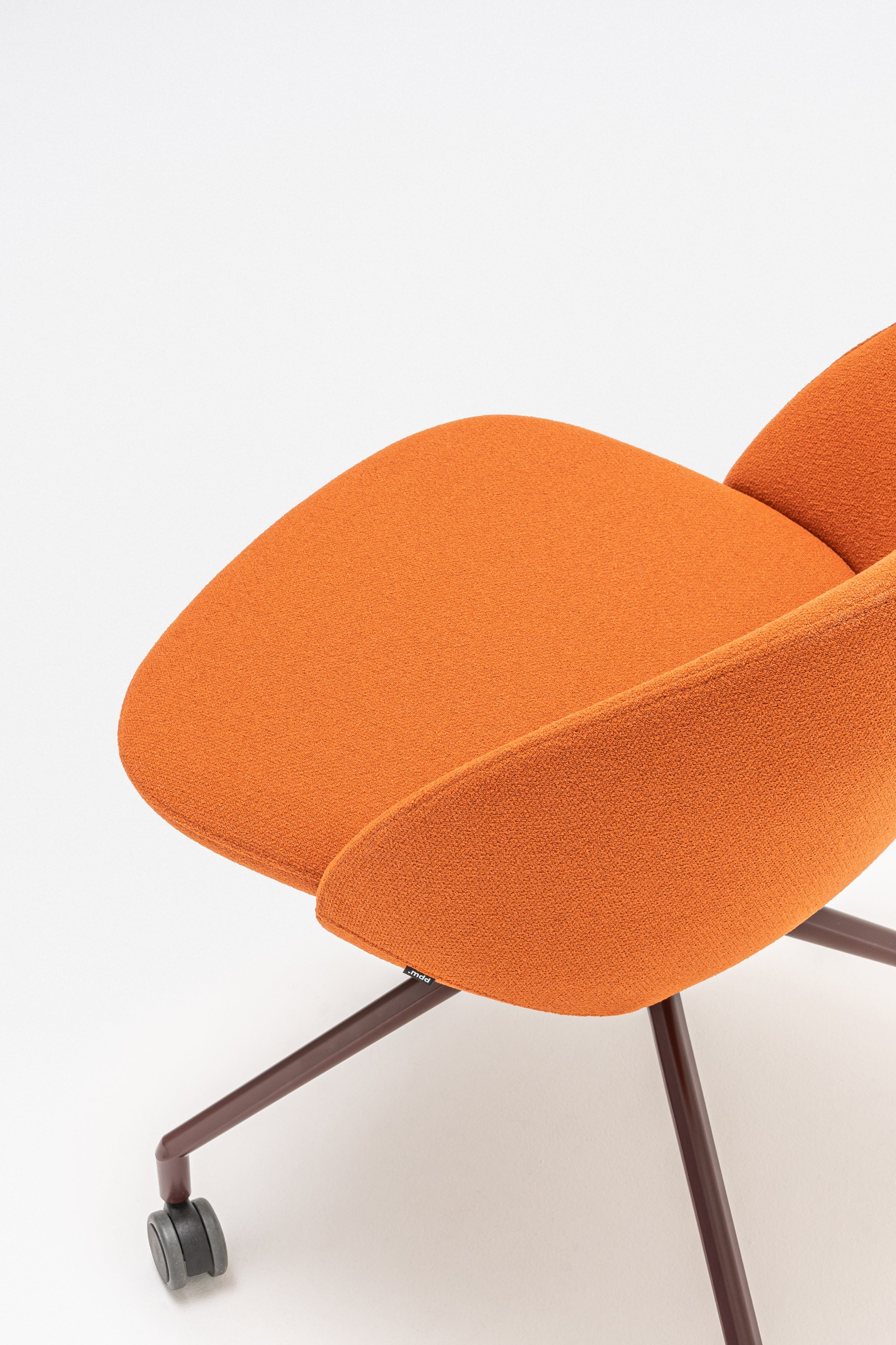 Swivel armchair with low back, a metal parallel base with wheels to a hard surface