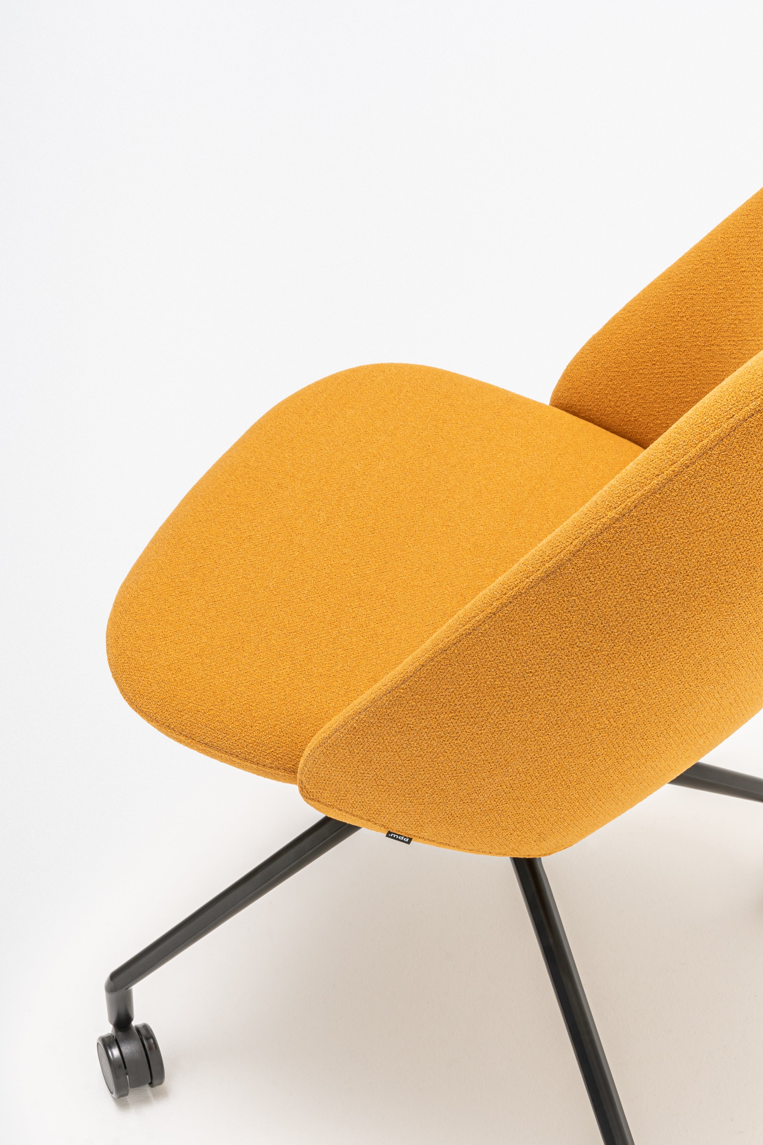 Rotable armchair with a high back, a metal parallel base with wheels to a soft surface