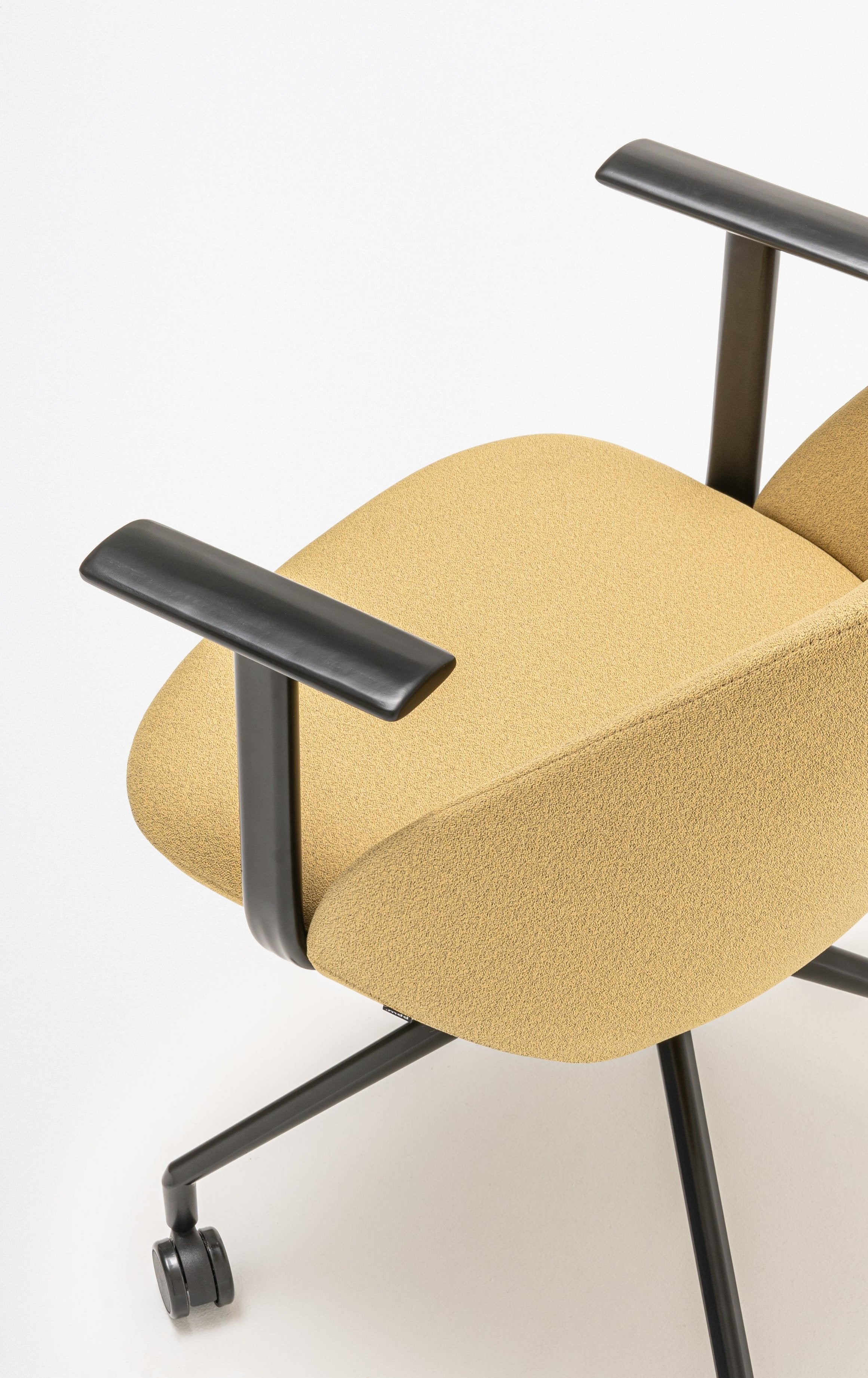Rotable armchair with a high back, a metal parallel base with wheels to a soft surface