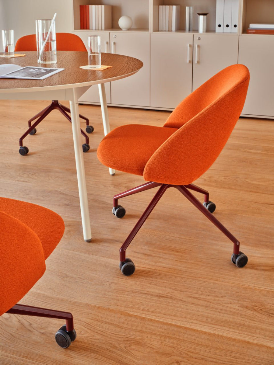 Swivel armchair with low back, a metal parallel base with wheels to a hard surface