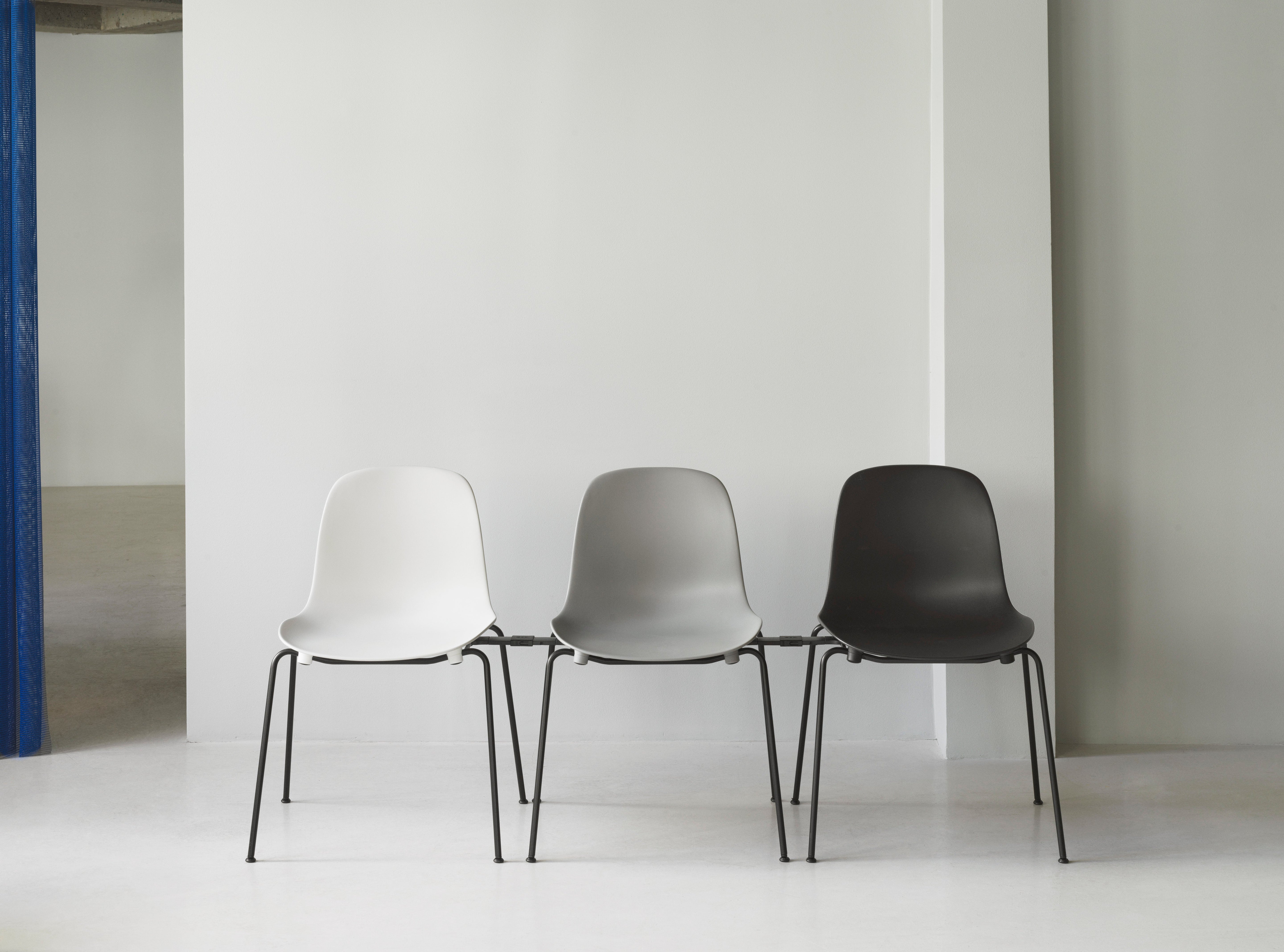 Upholstered chair forms of Stacking with a black base