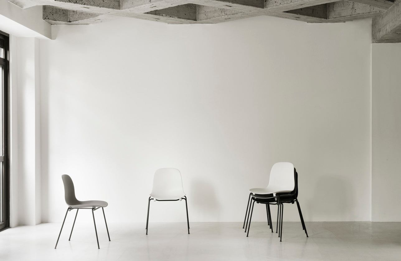 Upholstered chair forms of Stacking with a black base