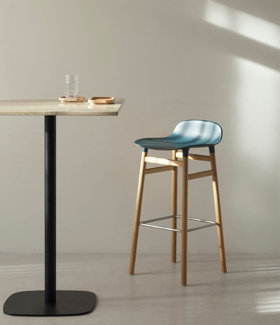 A square cafe table forms wooden top with a black base
