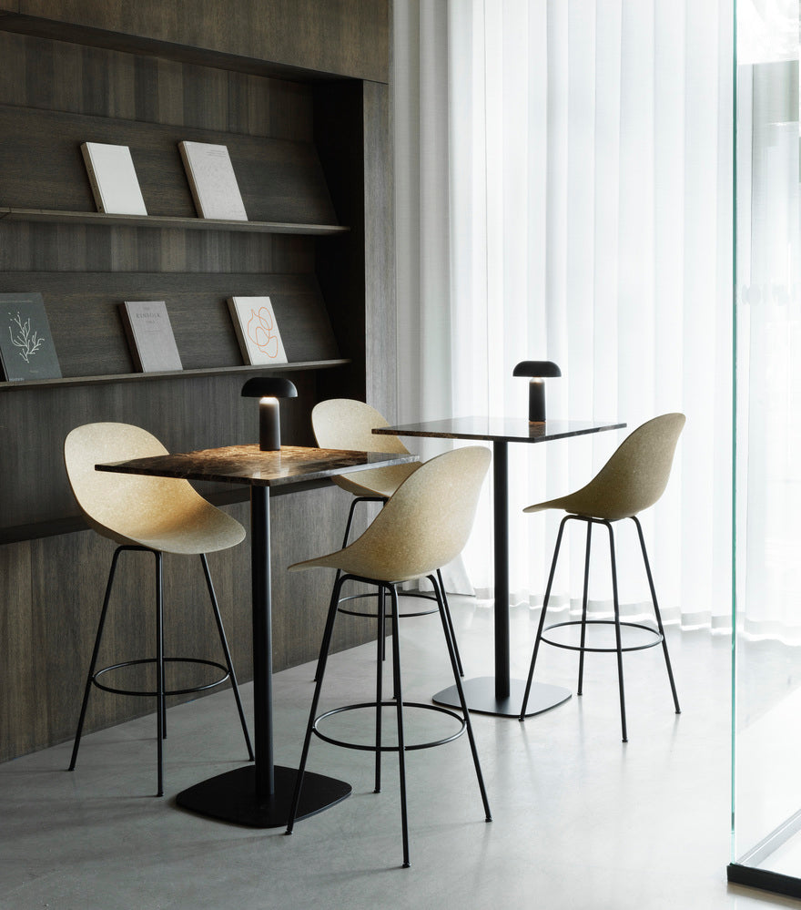 Round cafe table forms wooden top with a black base
