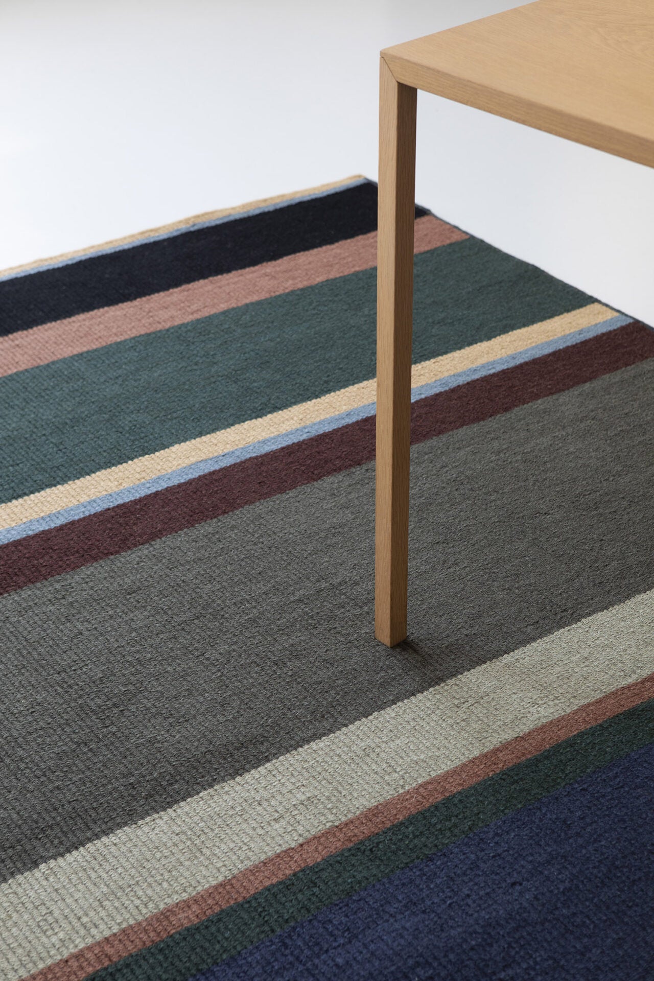 Artisan stack navy-green stack rug