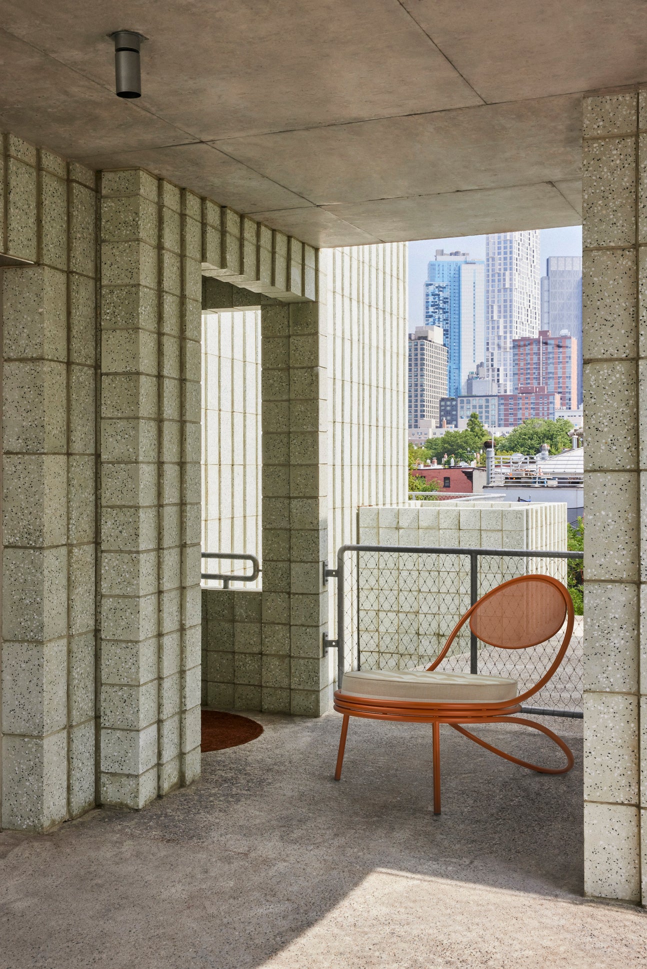 COPACABANA armchair upholstered with an orange base