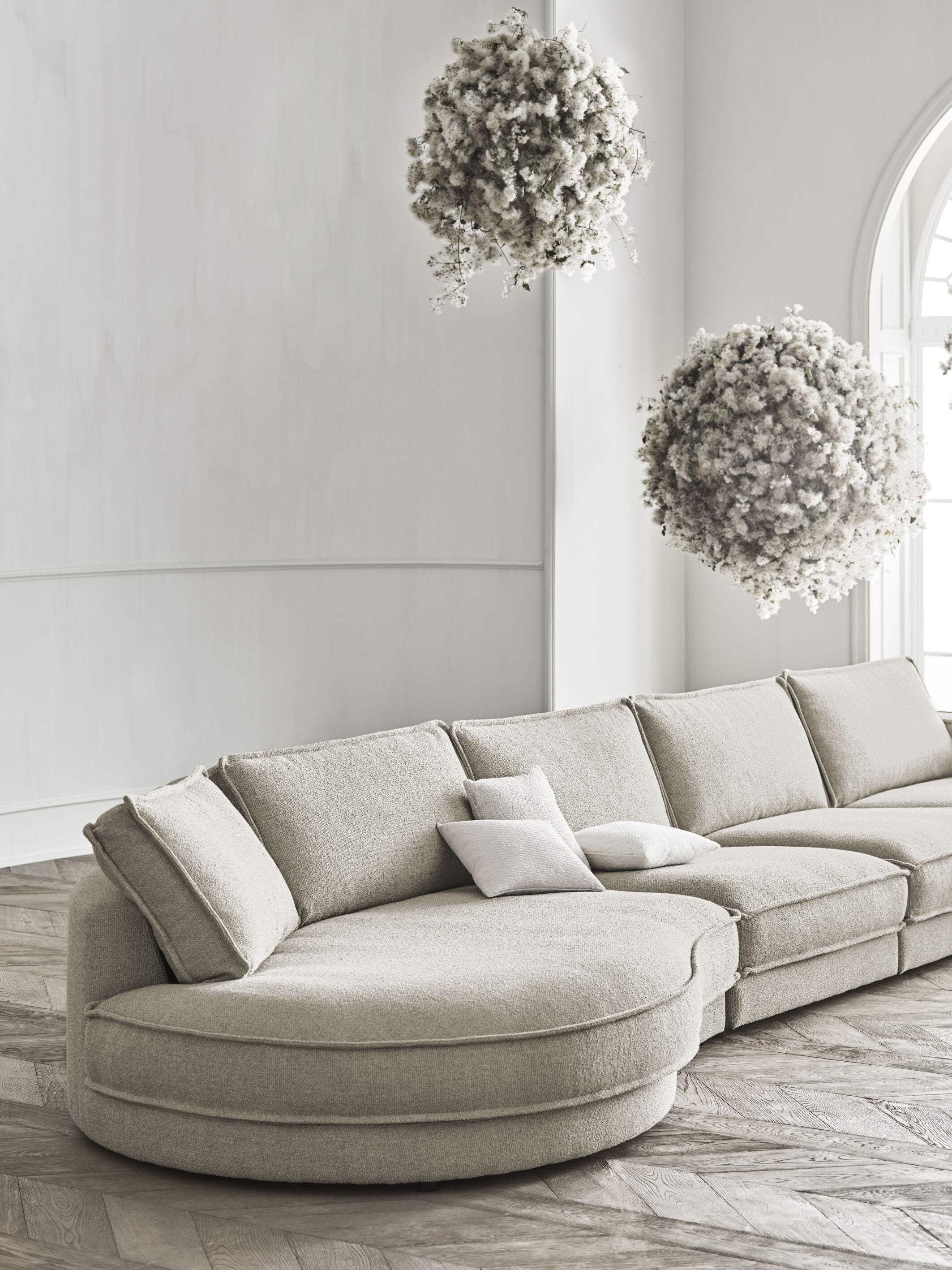 NOORA 3-modulus sofa with a rounded left side and a dark base