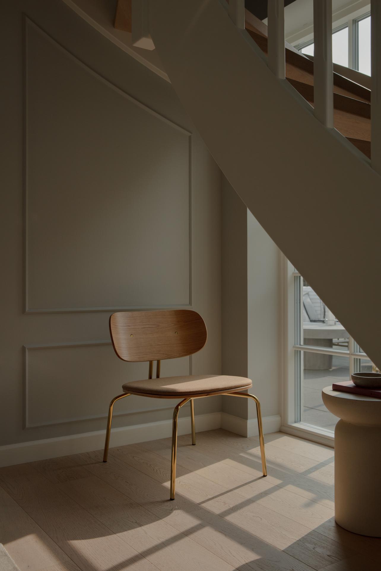 Black beige curious armchair with a black base