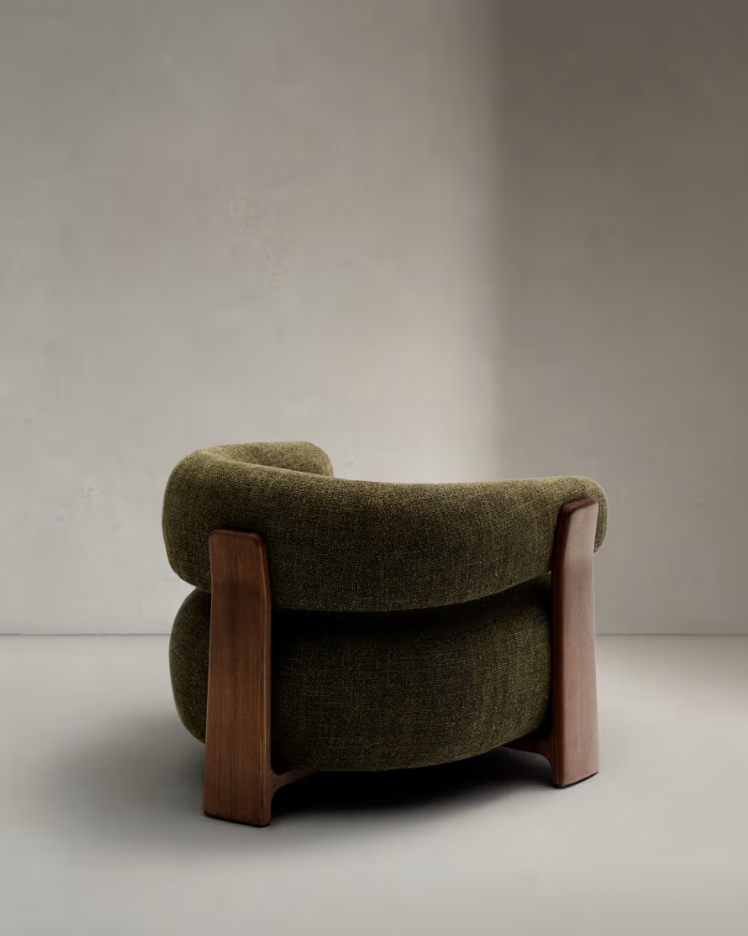 Green green armchair with a dark wooden base