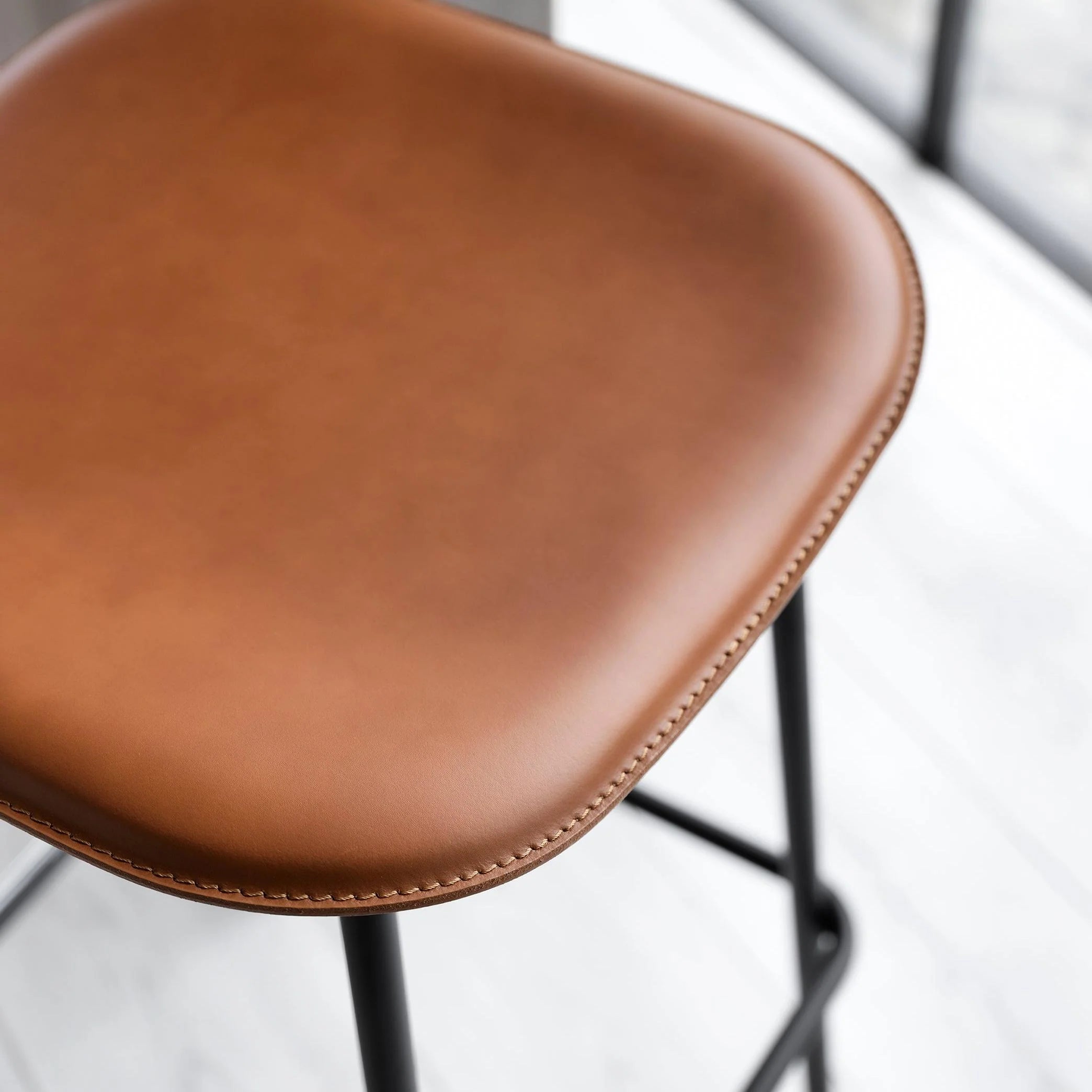 FIFTIES upholstered bar stool with a black base
