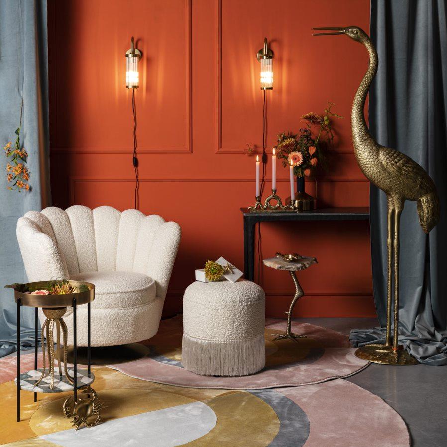 Wherever you put it, the Bold Monkey Mother of All Shells chair catches your attention. Upholstered in a rich natural texture in a plush color, the elegant style of the 70s is finished with gold-covered gold base.