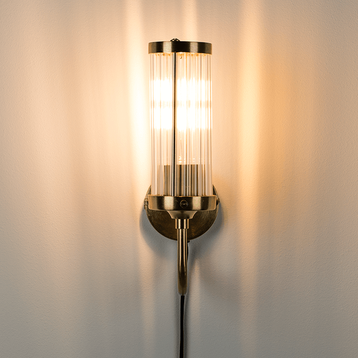Modern acrylic design tubes are complemented by a matte brass wall finish. Thanks to our fashionable Angel On Fire wall lamp, you can softly and stylishly illuminate the wall in the gallery or add the glow of empty wall space. Style that