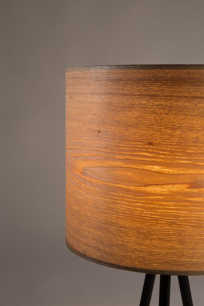 The Woodland table lamp is a retro style in a completely new version. The lamp has a lampshade with a classic, simple, regular shape. The lampshade was made of ash veneer, which distracts the light and spreads a warm and pleasant atmosphere. Veneer is flexible enough and can be formed in such calm and regular shapes.